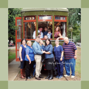 Aucoin & Sciortino families in front of a Streetcar