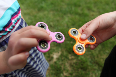 children playing with fidget spinners