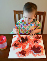 child painting leaves