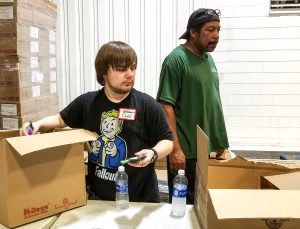 Christopher Walther, 17, a senior at Destrehan High School, volunteers at Second Harvest Food Bank in New Orleans to help fill backpacks with food for kids to take home from school over the weekend.