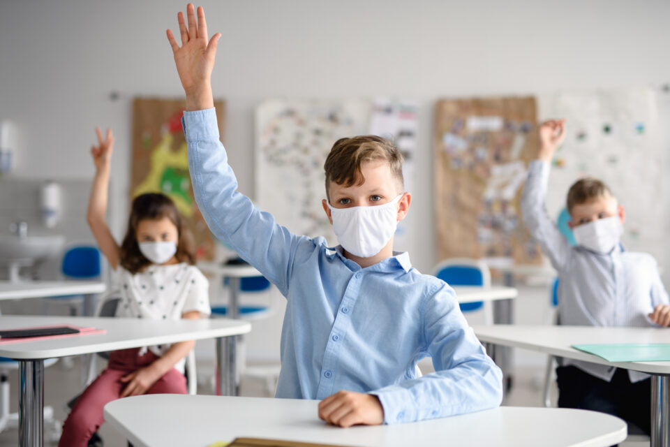 School children masked and socially distanced in the classroom